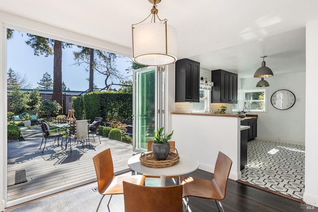 dining space featuring baseboards and wood finished floors
