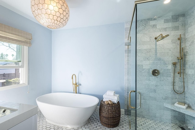 bathroom featuring a stall shower, a freestanding tub, tile patterned flooring, and vanity
