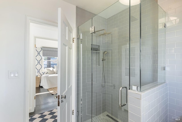 ensuite bathroom with connected bathroom and a stall shower