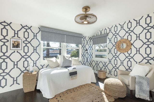 bedroom with wallpapered walls, baseboards, and wood finished floors