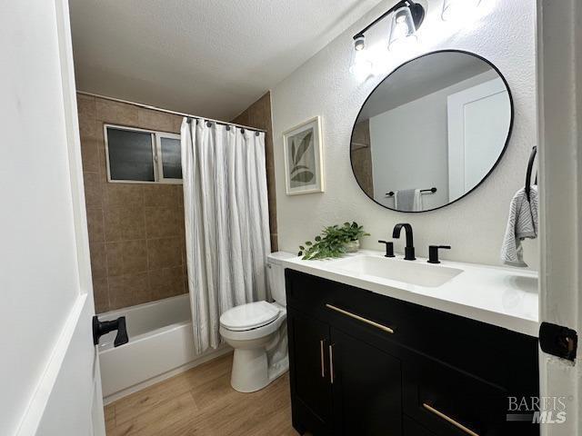 1242 Van Buren St, Fairfield, CA 94533 - bathroom featuring toilet, wood finished floors, vanity, and shower / tub combo