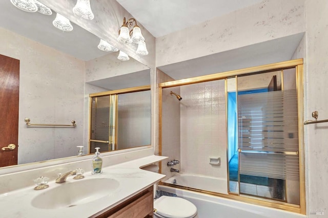 bathroom with toilet, enclosed tub / shower combo, and vanity