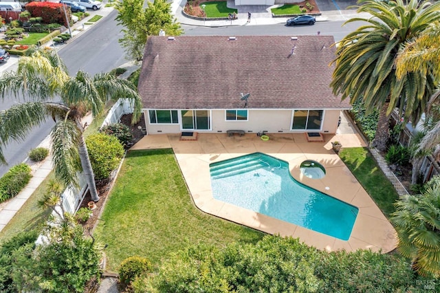 back of house featuring a patio, a fenced backyard, stucco siding, and a lawn