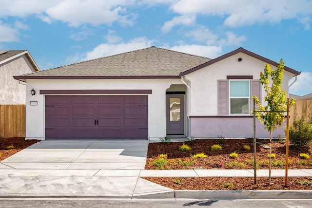 ranch-style house featuring a garage, fence, stucco siding, and concrete driveway