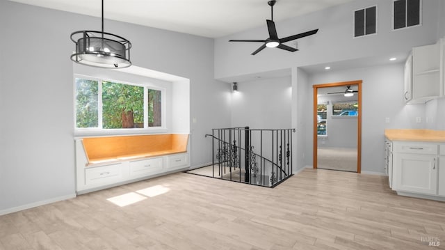 unfurnished room with plenty of natural light, visible vents, and a ceiling fan