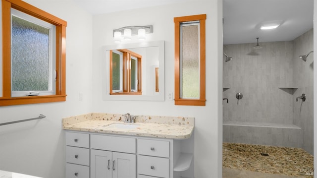 bathroom featuring vanity and a tile shower