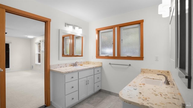 bathroom featuring baseboards and vanity