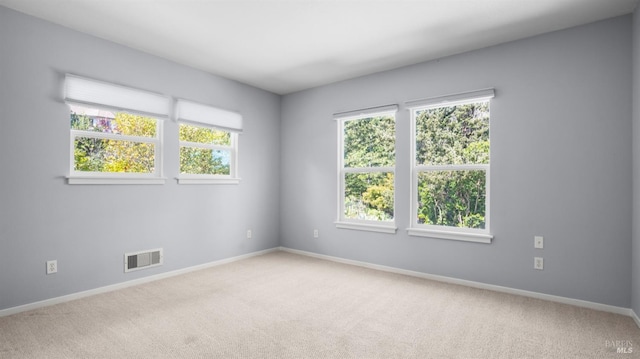 carpeted empty room with baseboards and visible vents