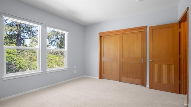 unfurnished bedroom featuring carpet and baseboards