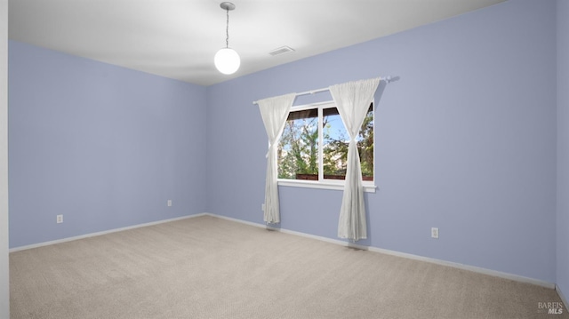 carpeted empty room with baseboards and visible vents