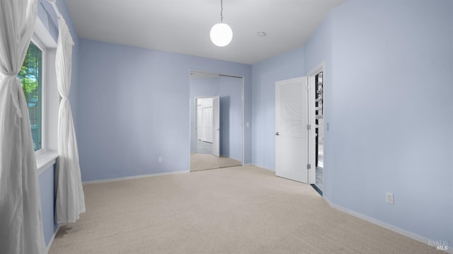 empty room with carpet and baseboards
