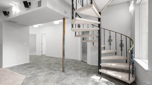 staircase with baseboards and visible vents