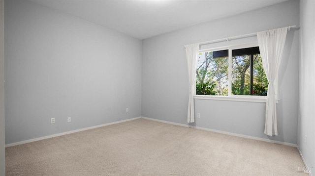 empty room with carpet flooring and baseboards