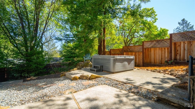 view of patio with a hot tub and a fenced backyard