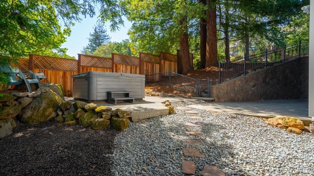 view of yard with a hot tub and fence