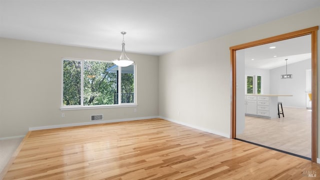 empty room featuring visible vents, a healthy amount of sunlight, recessed lighting, and light wood finished floors