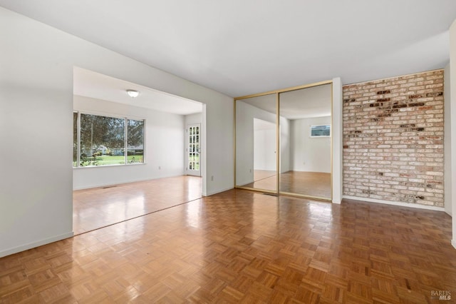 interior space with brick wall and baseboards