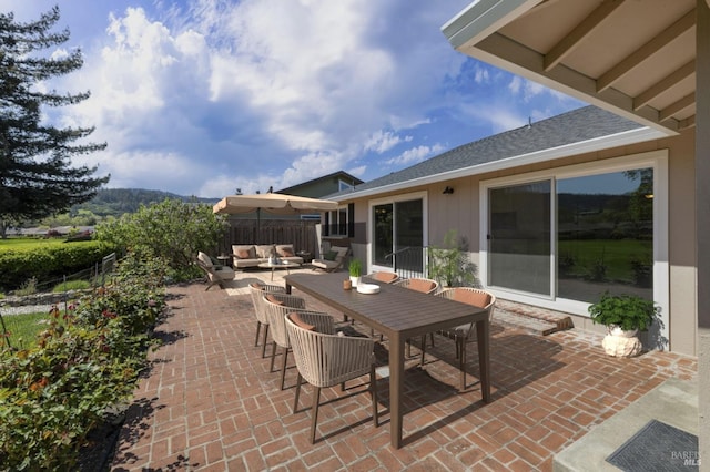 view of patio / terrace with outdoor dining space, an outdoor living space, and fence