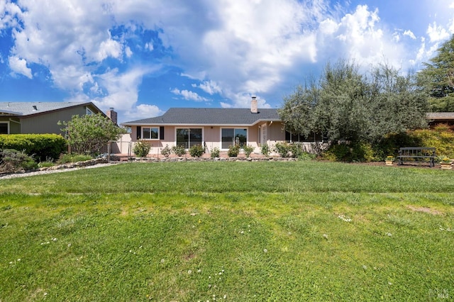 ranch-style house with a chimney and a front yard