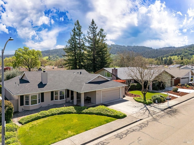 single story home featuring a front yard, a garage, a chimney, stucco siding, and driveway