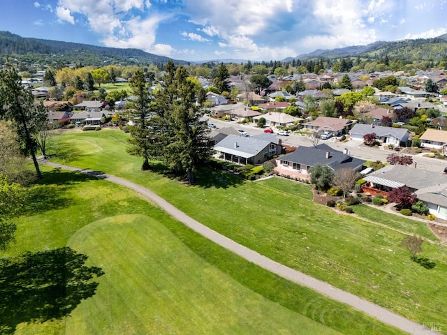 birds eye view of property with a mountain view, view of golf course, and a residential view