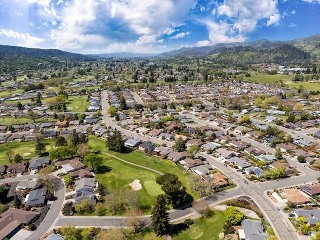 birds eye view of property featuring a mountain view, a residential view, and view of golf course