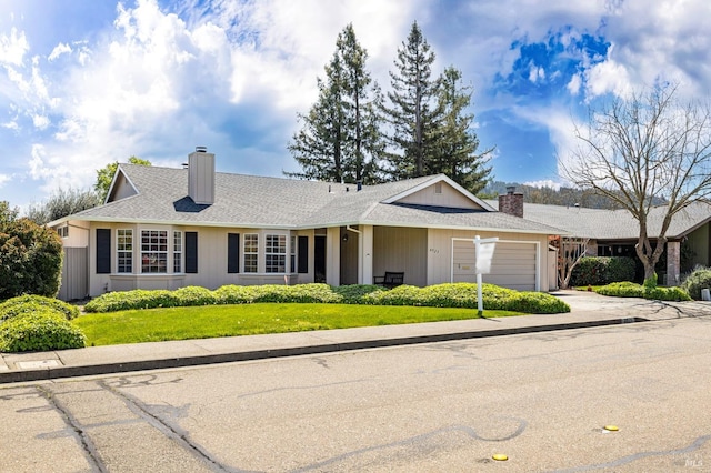 single story home with a garage, roof with shingles, a chimney, and concrete driveway