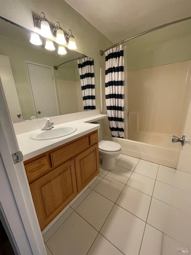 bathroom with toilet, tile patterned flooring, vanity, and shower / bath combo