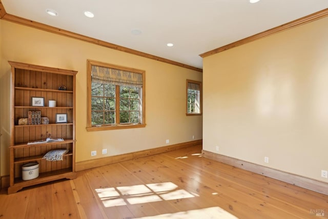 spare room with wood-type flooring, crown molding, baseboards, and recessed lighting
