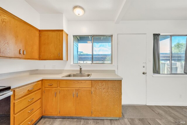 1008 Los Gamos Rd Unit F, San Rafael, CA 94903 - kitchen featuring a sink, light wood-style floors, light countertops, brown cabinets, and electric stove