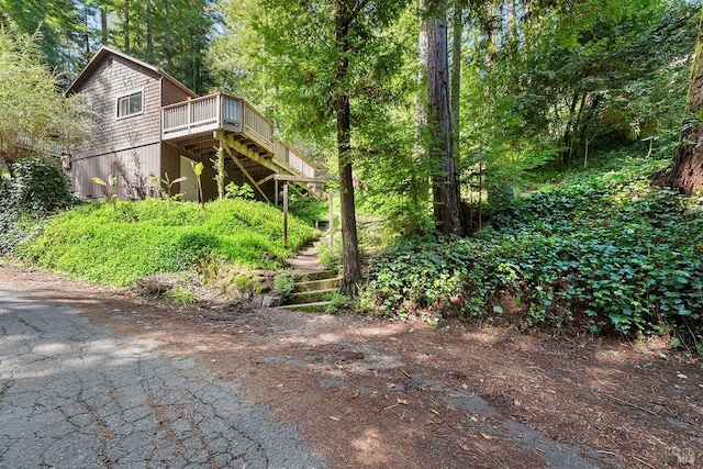 view of yard featuring a deck and stairway