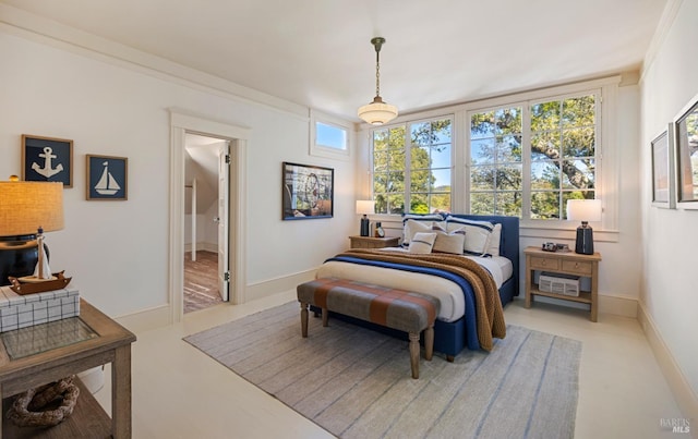 bedroom featuring baseboards and ensuite bath