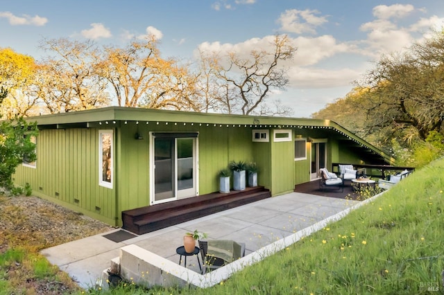 rear view of house featuring crawl space and a patio area