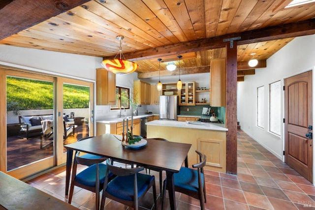 dining space featuring wood ceiling, dark tile patterned floors, and beam ceiling