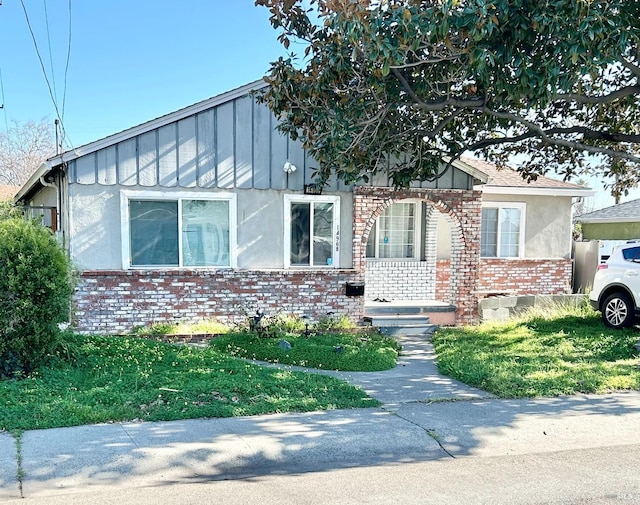 view of front of property with stucco siding and brick siding