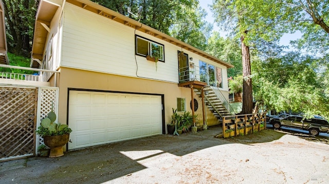 317 Olema Rd, Fairfax, CA 94930 - view of front of home featuring concrete driveway, an attached garage, stairway, and stucco siding
