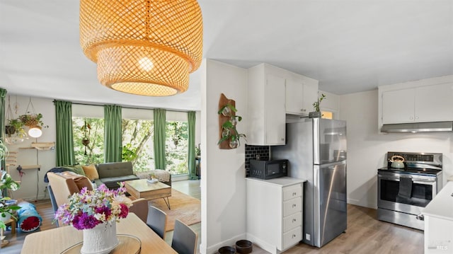317 Olema Rd, Fairfax, CA 94930 - kitchen featuring appliances with stainless steel finishes, under cabinet range hood, light wood-type flooring, white cabinets, and light countertops