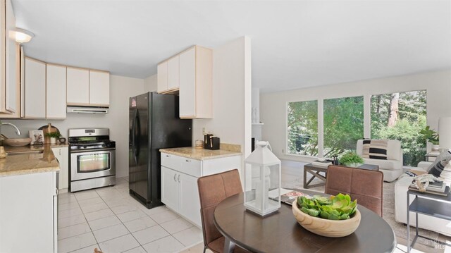 317 Olema Rd, Fairfax, CA 94930 - kitchen with stainless steel gas stove, freestanding refrigerator, exhaust hood, a sink, and light countertops