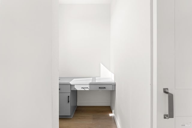 bathroom featuring wood finished floors and baseboards
