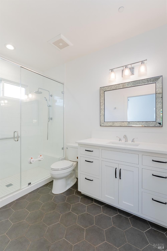 full bathroom with vanity, toilet, tile patterned floors, a stall shower, and visible vents