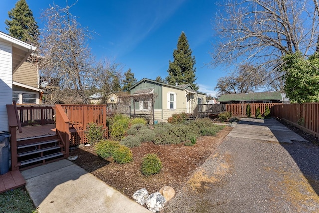 view of side of property featuring fence and a deck