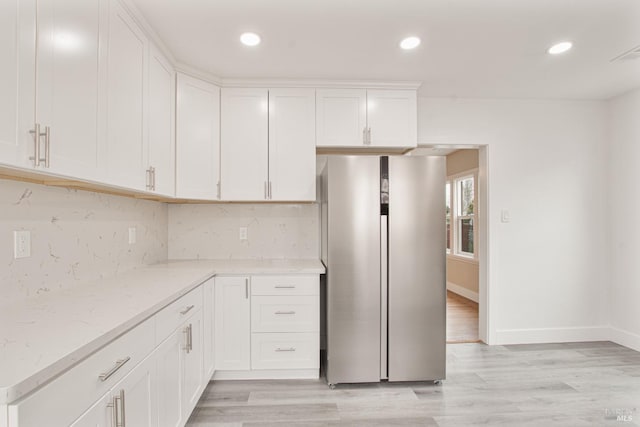 308 Central Ave, Vallejo, CA 94590 - kitchen with tasteful backsplash, freestanding refrigerator, white cabinetry, and light stone countertops