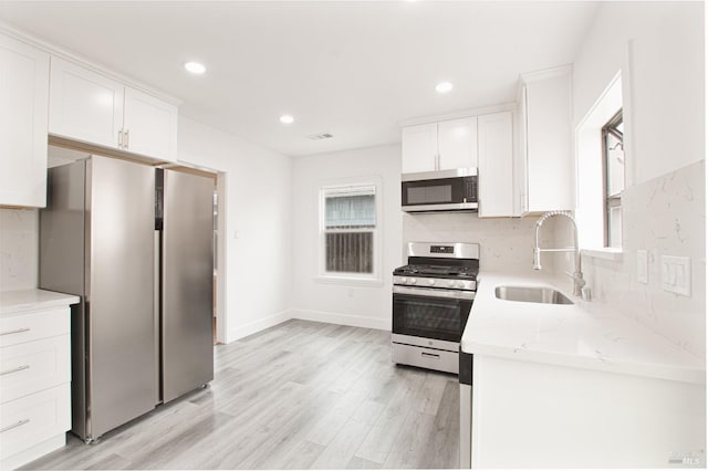 308 Central Ave, Vallejo, CA 94590 - kitchen with a sink, stainless steel appliances, light wood-type flooring, and white cabinetry