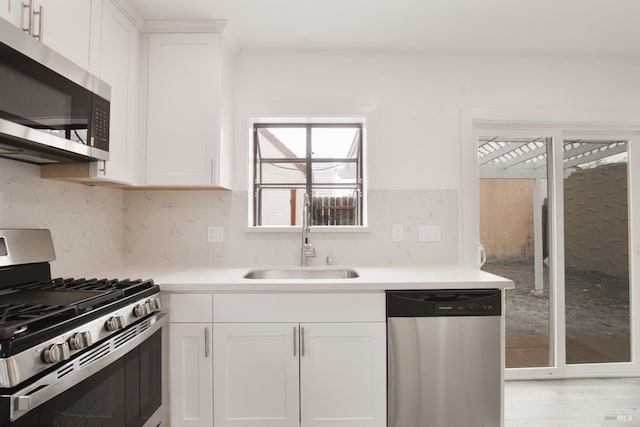 308 Central Ave, Vallejo, CA 94590 - kitchen featuring a sink, light countertops, stainless steel appliances, and white cabinetry