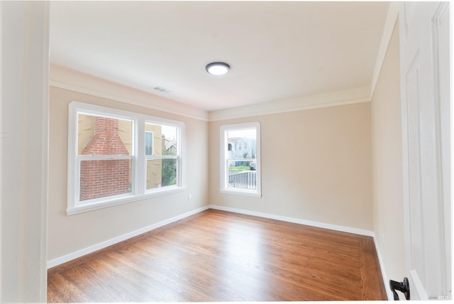 308 Central Ave, Vallejo, CA 94590 - unfurnished room featuring crown molding, baseboards, visible vents, and wood finished floors