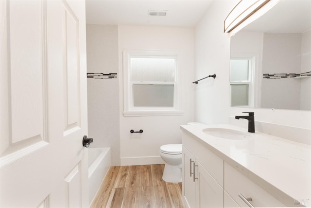 308 Central Ave, Vallejo, CA 94590 - bathroom featuring vanity, toilet, a bathtub, wood finished floors, and visible vents