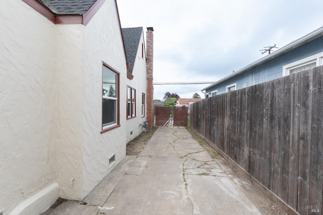 308 Central Ave, Vallejo, CA 94590 - view of property exterior with roof with shingles, stucco siding, a fenced backyard, a chimney, and a patio