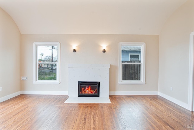 308 Central Ave, Vallejo, CA 94590 - unfurnished living room featuring baseboards, a premium fireplace, wood finished floors, and lofted ceiling