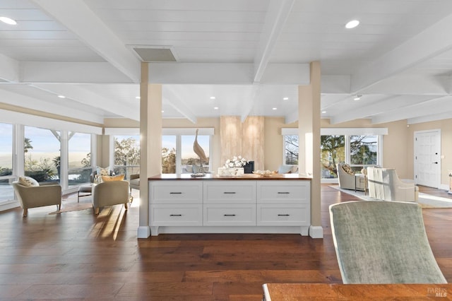 kitchen with open floor plan, white cabinets, dark wood-style flooring, and a healthy amount of sunlight