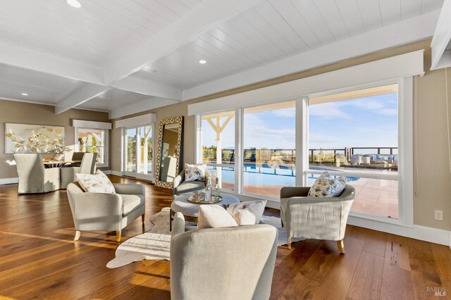 living room featuring baseboards, beam ceiling, recessed lighting, and wood-type flooring